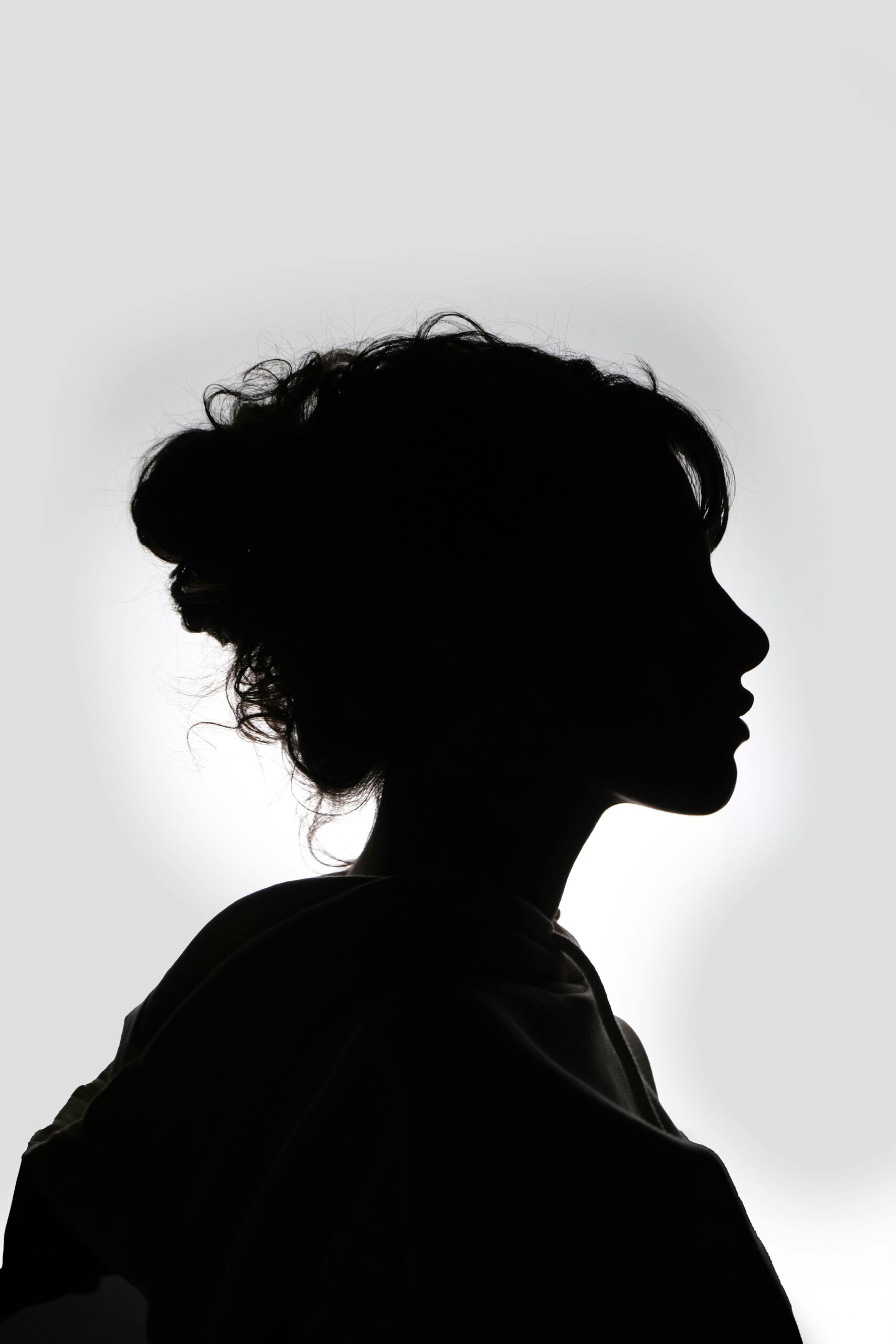 Striking black and white silhouette of a woman in profile, showcasing graceful features.